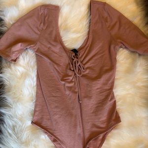 Peach colored body suit